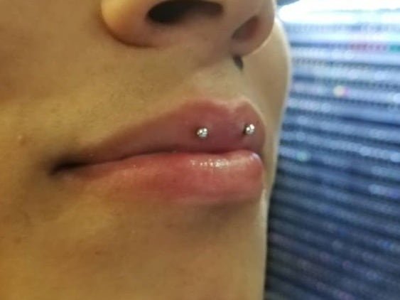 horizontal lip piercing on upper lip