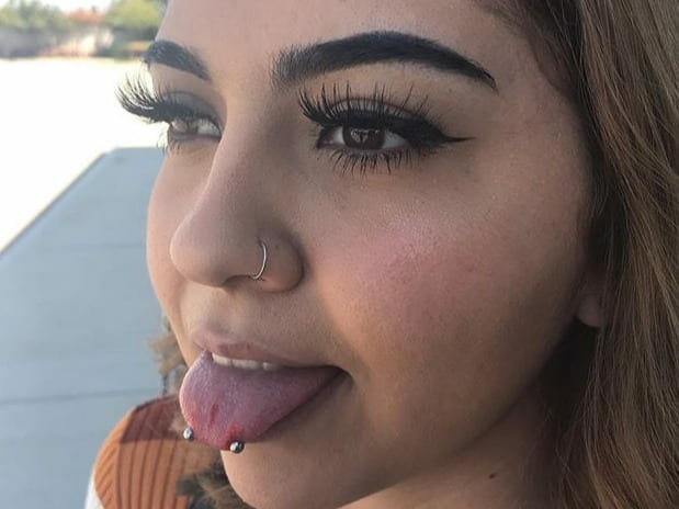 horizontal tongue piercing on girl