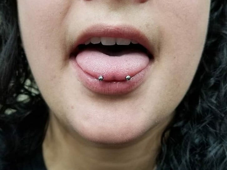 how to clean snake eyes tongue piercing