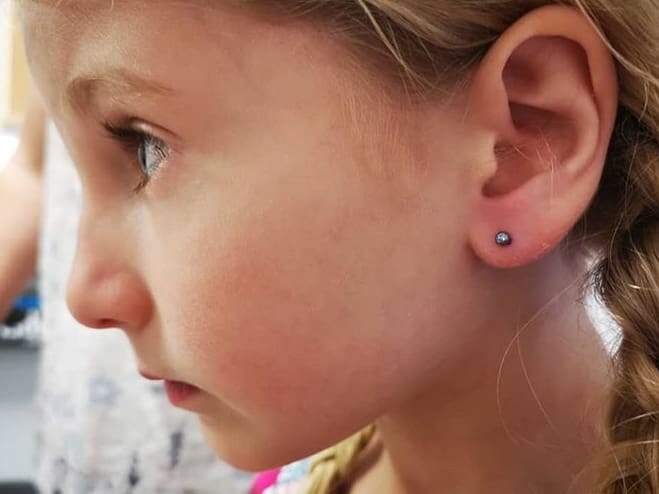 young girl earlobe piercing