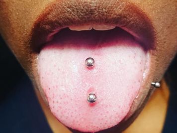 the double tongue piercing