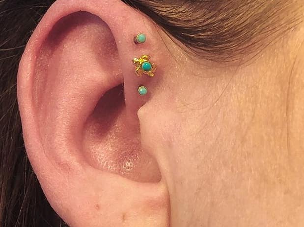 triple forward helix piercing on small ear